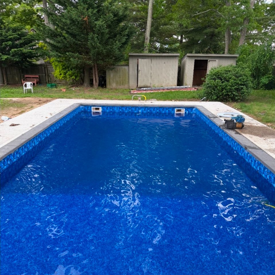 Rectangular inground pool filled with water after a new liner installation in Long Island NY