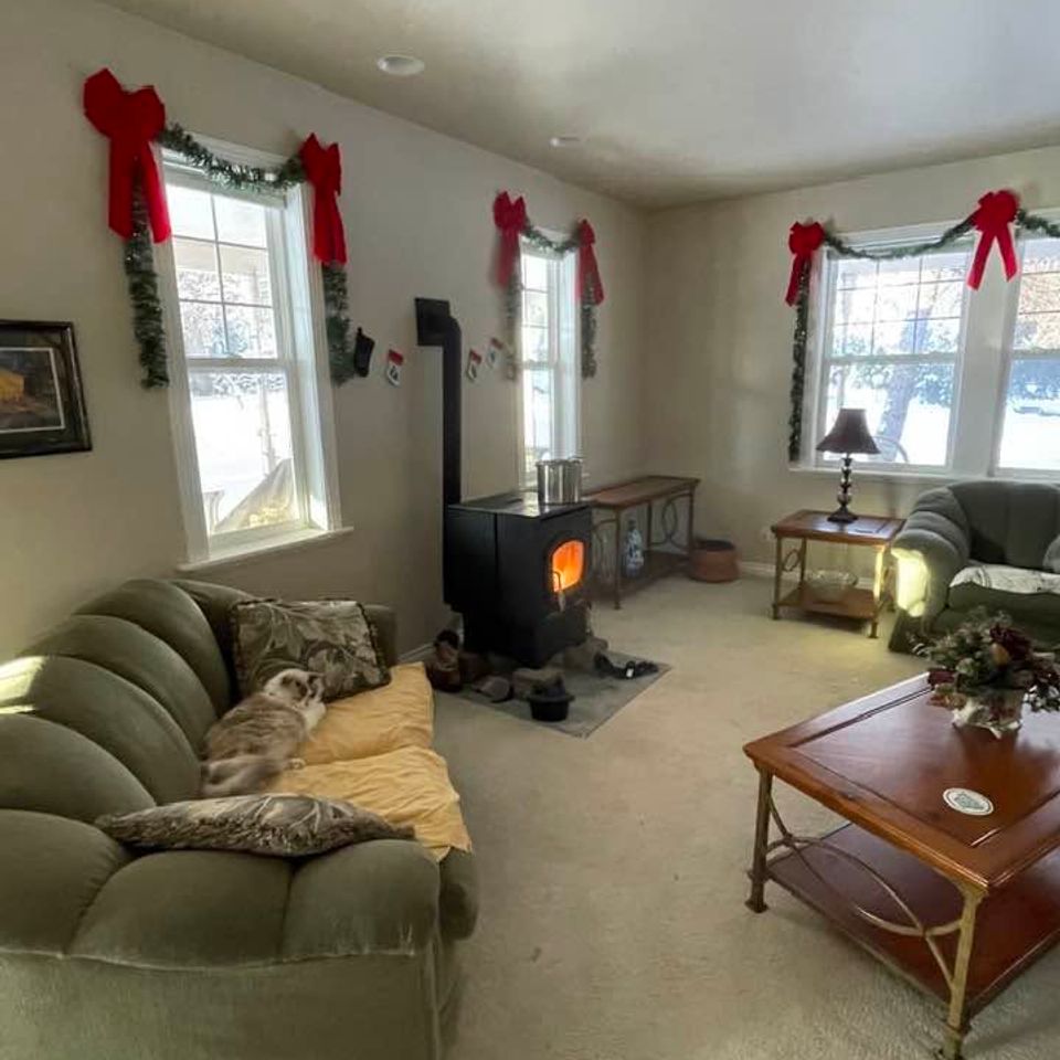 Cozy living room with wood stove and holiday decor inside a custom built home