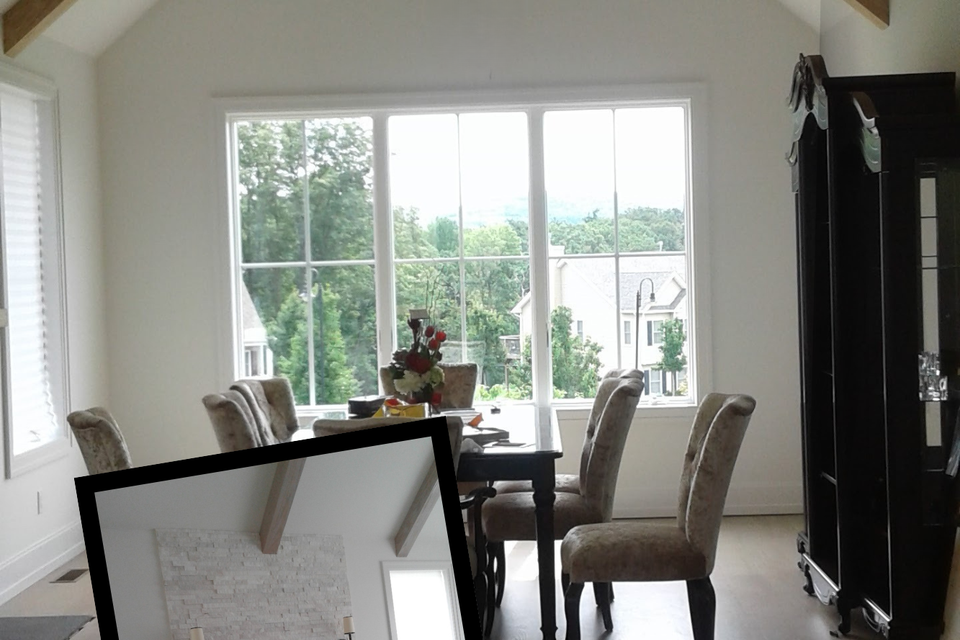 High-ceiling dining room with a modern fireplace and large windows.