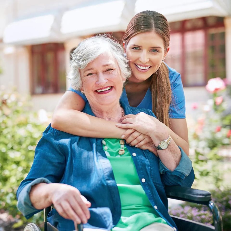A female nurse with her female patient smiling