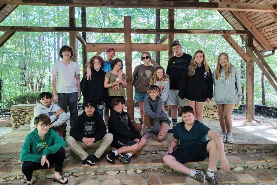 Gathering in front of cross children and youth