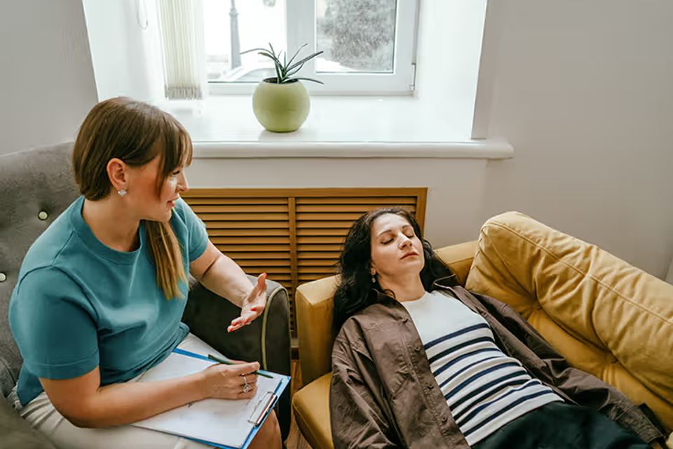 Psychologist therapist talking to patient lying on couch eyes closed 732x549 thumbnail