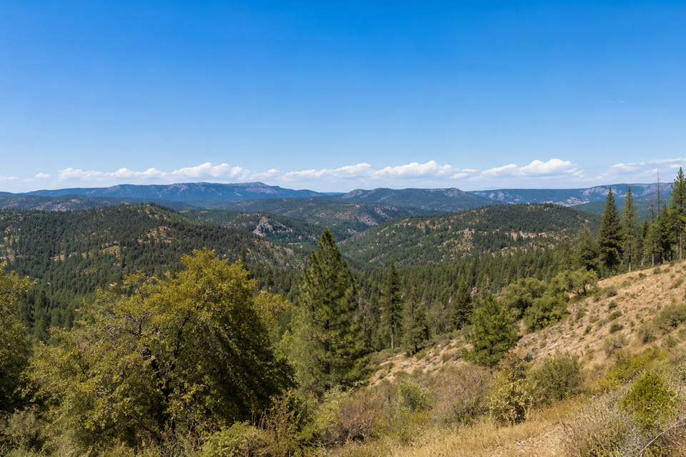 Defensible space around a rural home in el dorado county ca with cleared vegetation and surrounding forested hills (2)