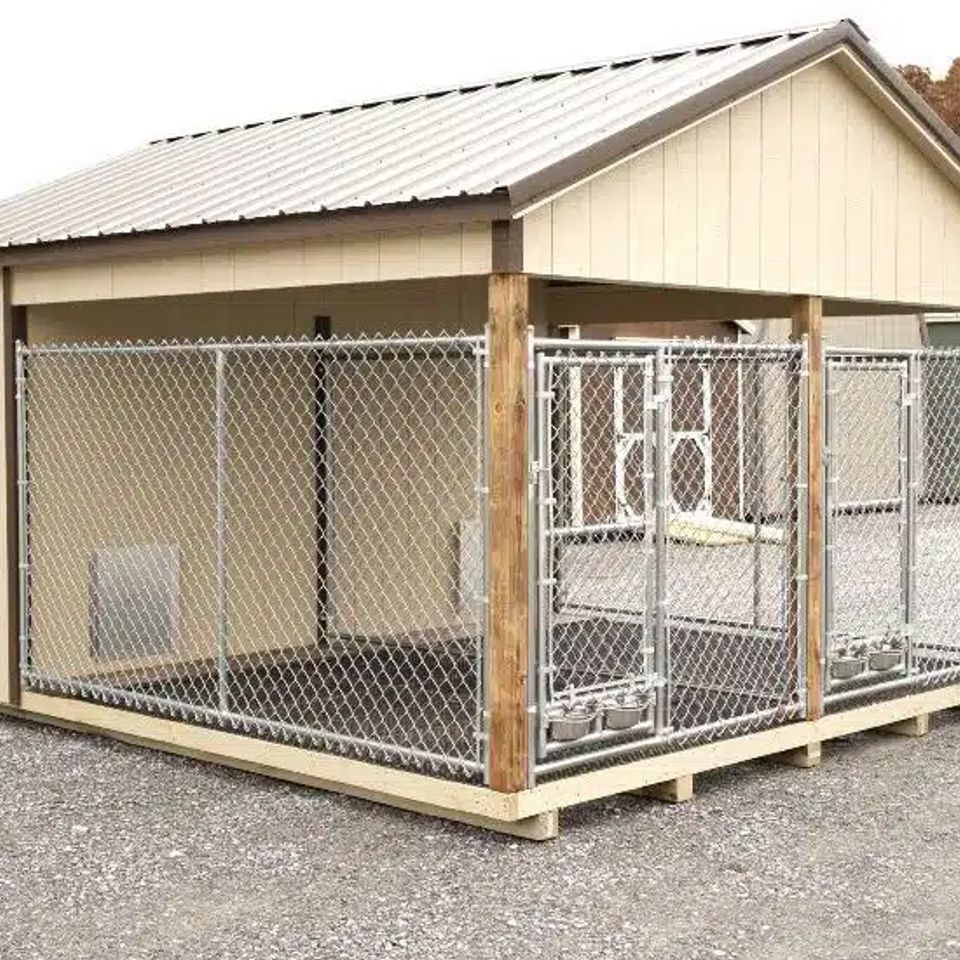 Tan dog kennel with double chain link runs and covered roof on an East Tennessee lot