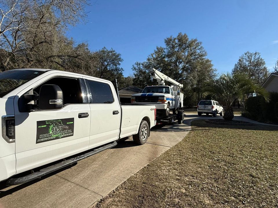 JNJ Hauling Solutions hauling a white truck
