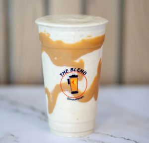 Peanut Butter Pump smoothie with peanut drizzle in a branded cup from The Blend.  Let me know if you'd like a shorter version or if this will be featured alongside other smoothie options so I can format it consistently.
