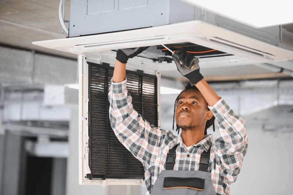 African american hvac technician repairing 600nw 2681324711