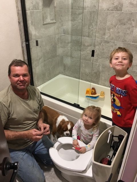 Kevin working on toilet repair