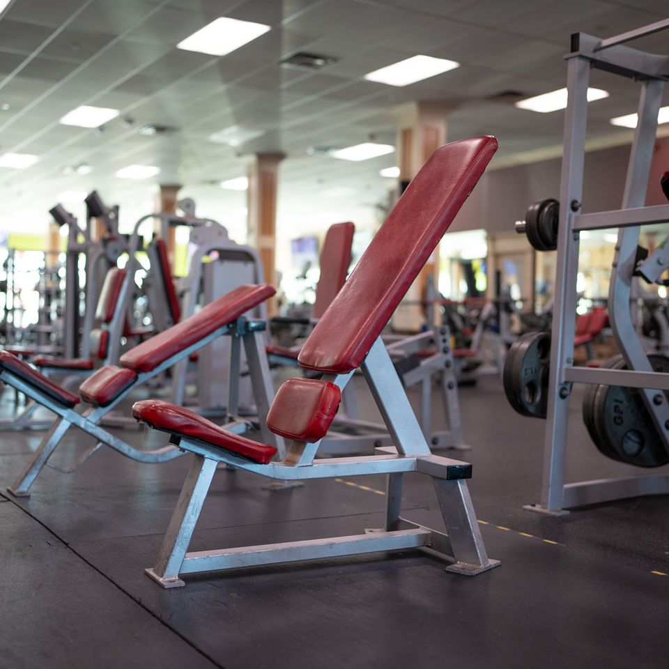 Red padded workout benches at Maximus Gym in Riverhead