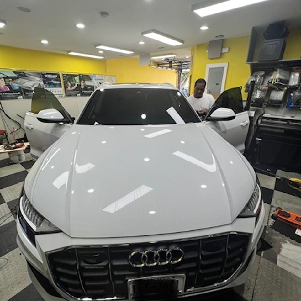 Window tint on windshield of white Audi SUV