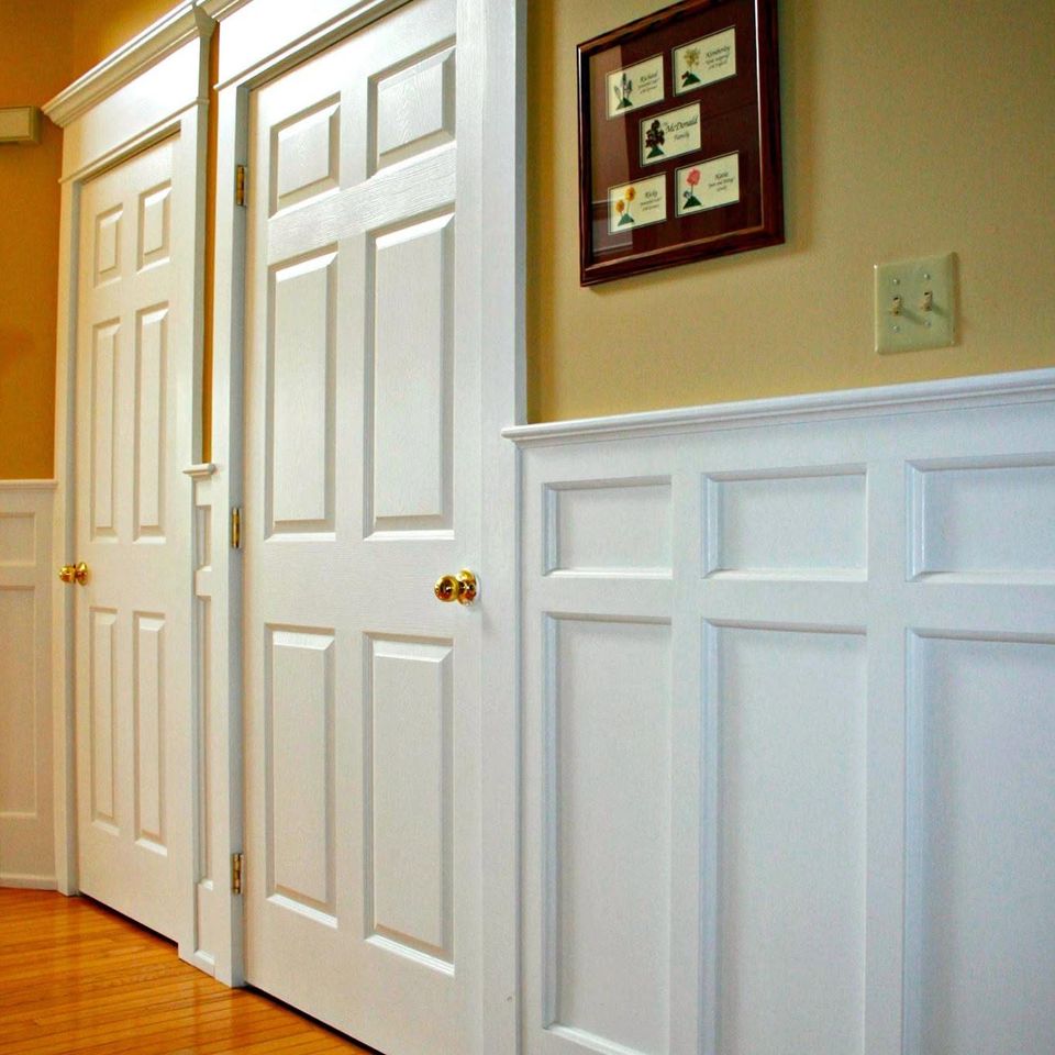 Hallway white wainscoting and doors