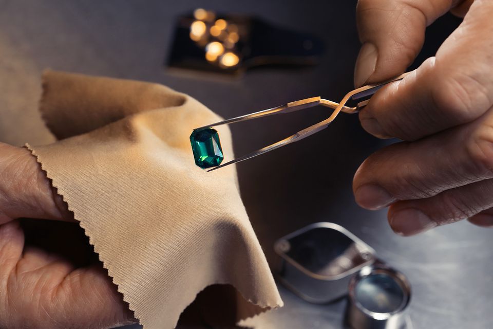 Jeweler showing an emerald.