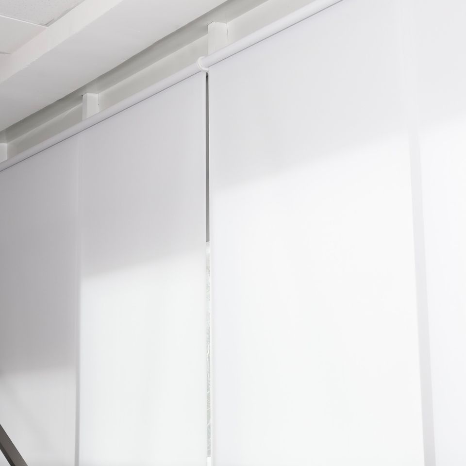 Manual and motorized window shades installed in a contemporary living room