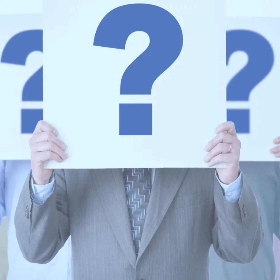 Businessman holding sign with question mark over his face