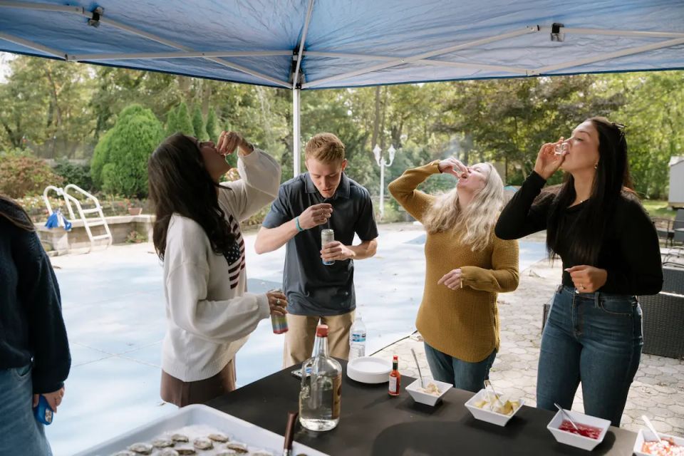 People enjoying themselves at a raw bar catering event, catered by Shore2Shore Shucking of Long Island