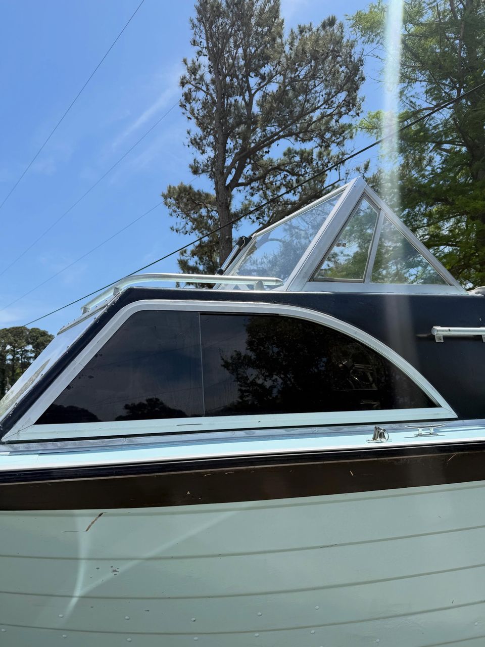 Boat windshield and side glass with marine window tint applied on a classic cabin boat