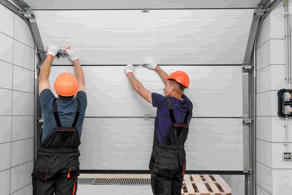 Workers are installing lifting gates garage (1)