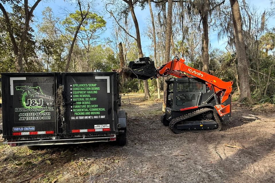 JNJ Hauling Solutions using a Kubota to remove junk from a job.