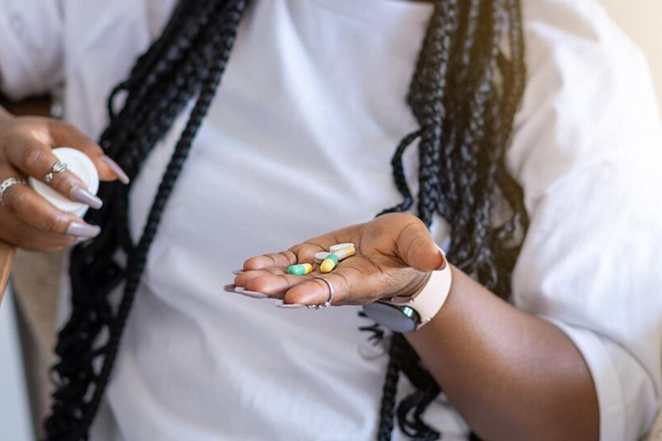 Woman holding glass water various pills palm her hand young woman preparing medication home 292052 6135