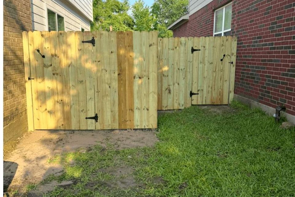 Wood fence with dual access gates between homes