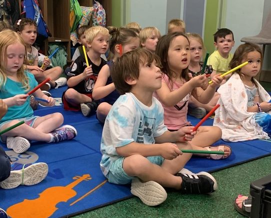 Kids playing rhythm sticks