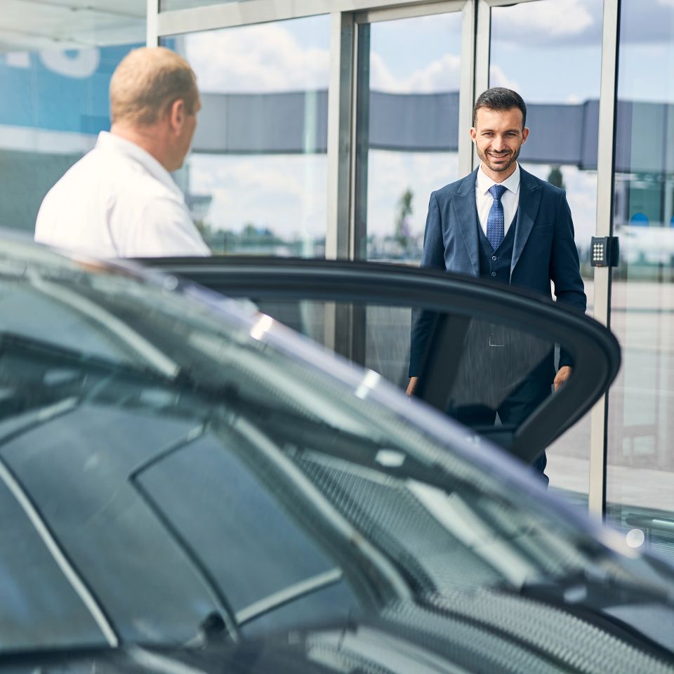 Joyful man smiling exiting the airport
