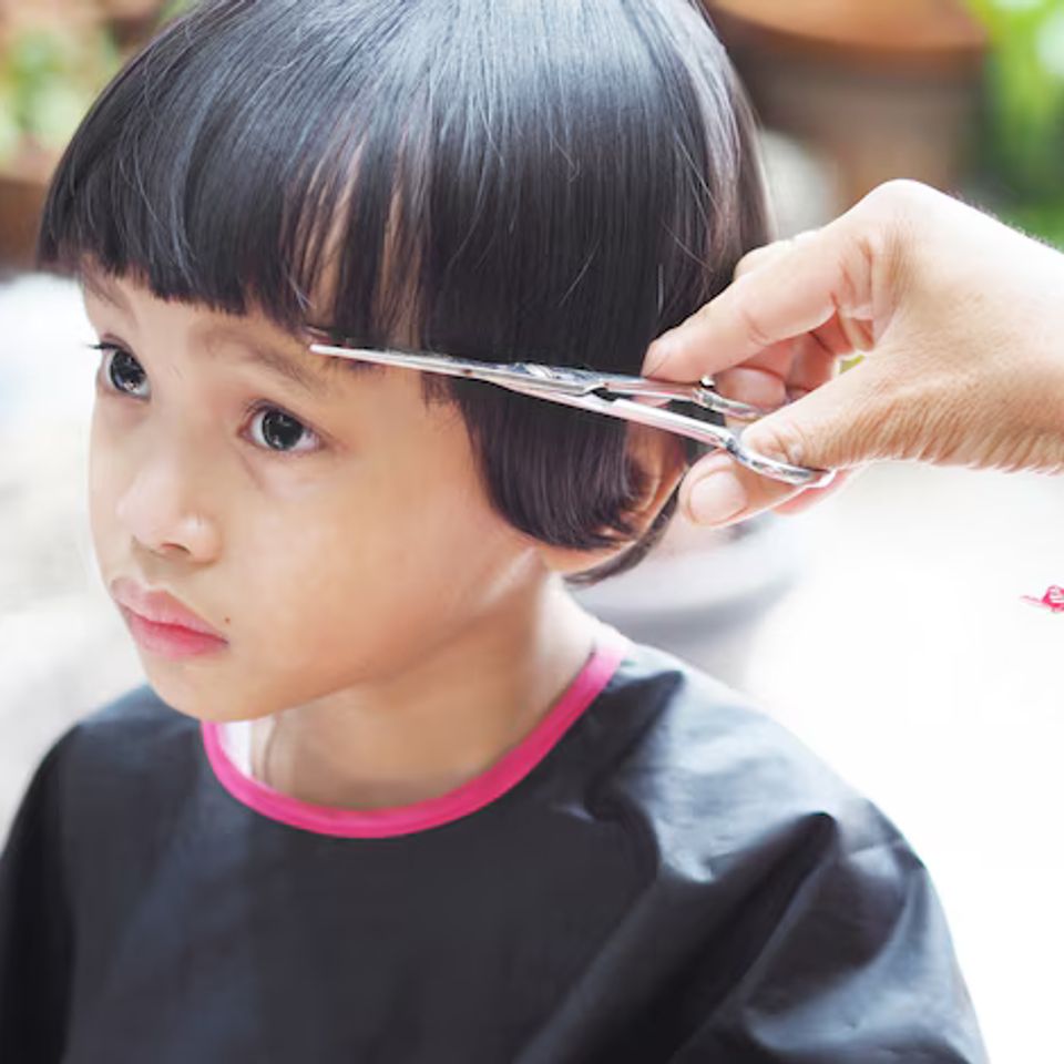 Cute little girl getting hair cut 42414 1484