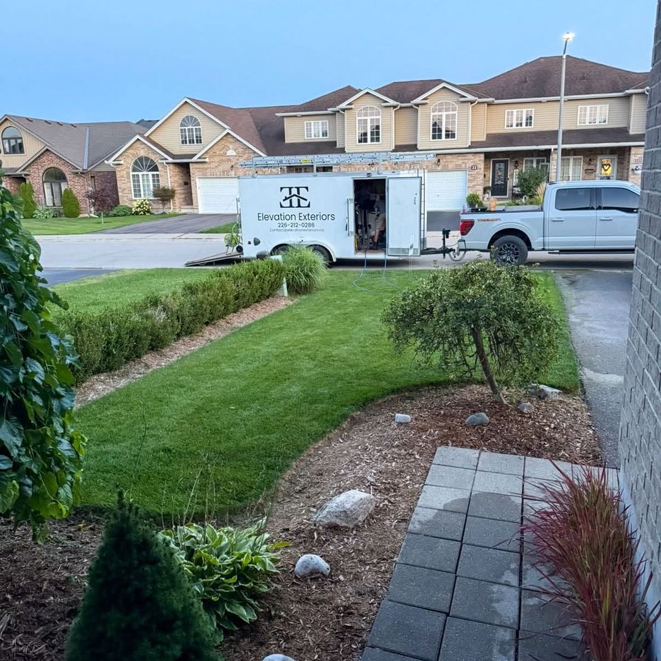 Elevation Exteriors trailer and truck parked at Tillsonburg townhomes with freshly cleaned front walkway