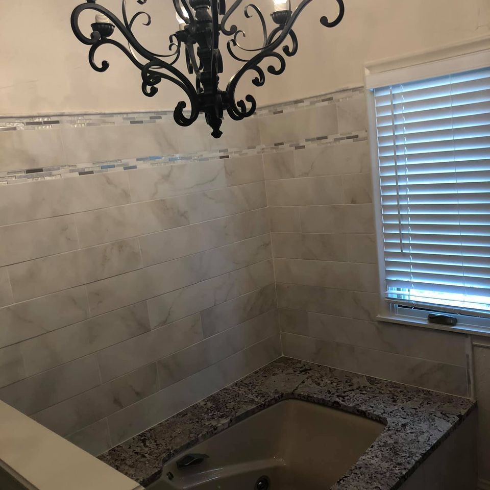3d solutions general contractors   tulsa oklahoma   bathroom remodel granite edge bathtub and modern tile surround after photo