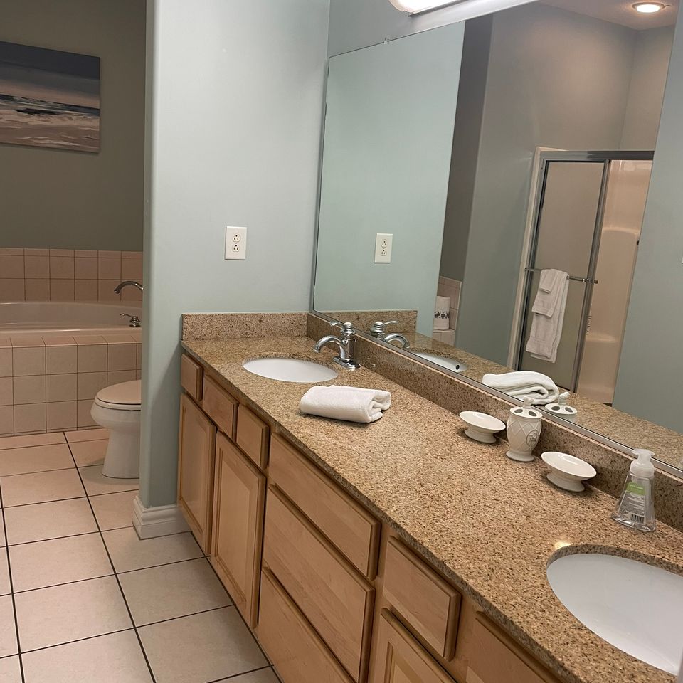 Clean bathroom vanity with granite counter and tile floor after house cleaning service in Virginia Beach VA