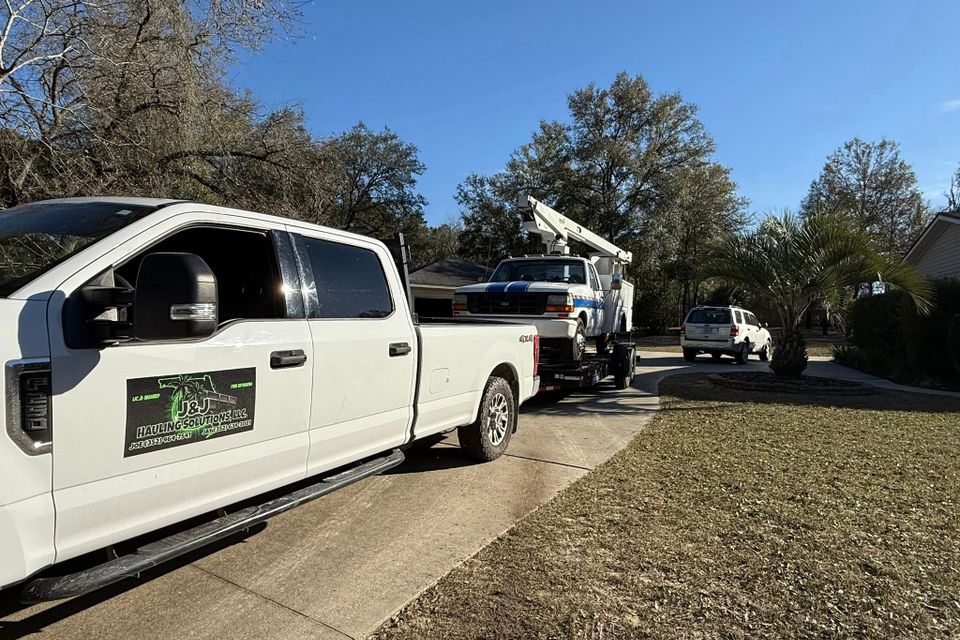JNJ Hauling Solutions hauling a white truck