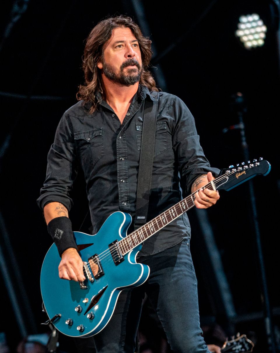 Dave Grohl playing his light blue guitar 