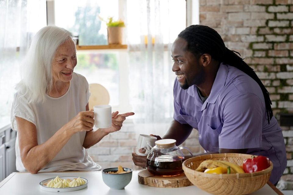 African social worker helping senior woman 23 2149031376