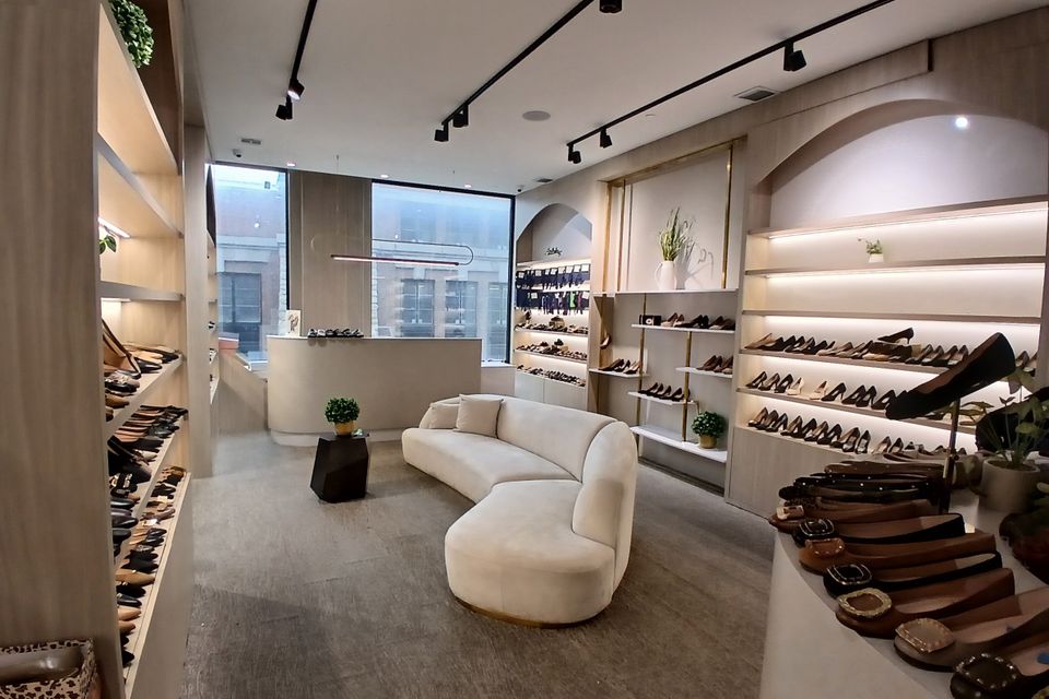 High-end cabinetry installation in a modern shoe store by Ultimate Kitchens.