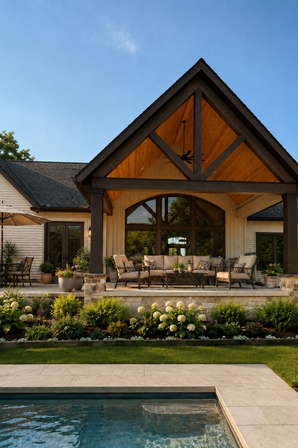 Covered outdoor living space overlooking the pool at a custom home in Hudson, Ohio