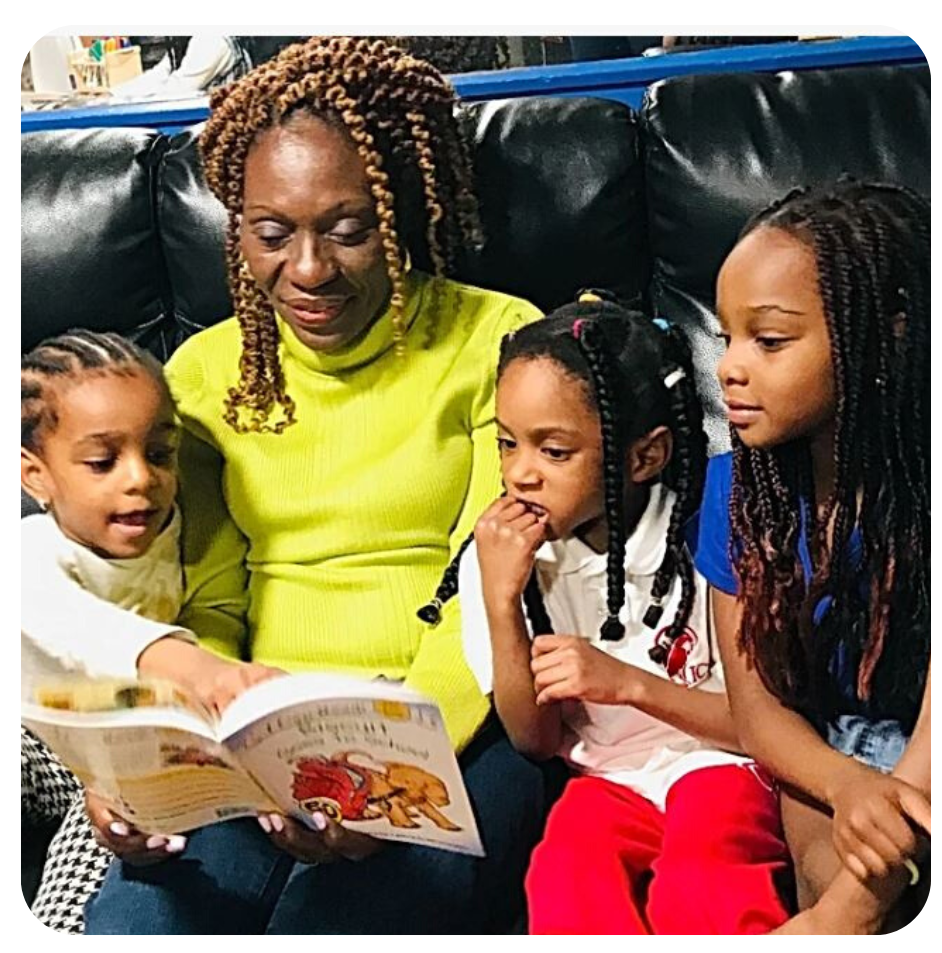 Esther reading on couch with children in frame
