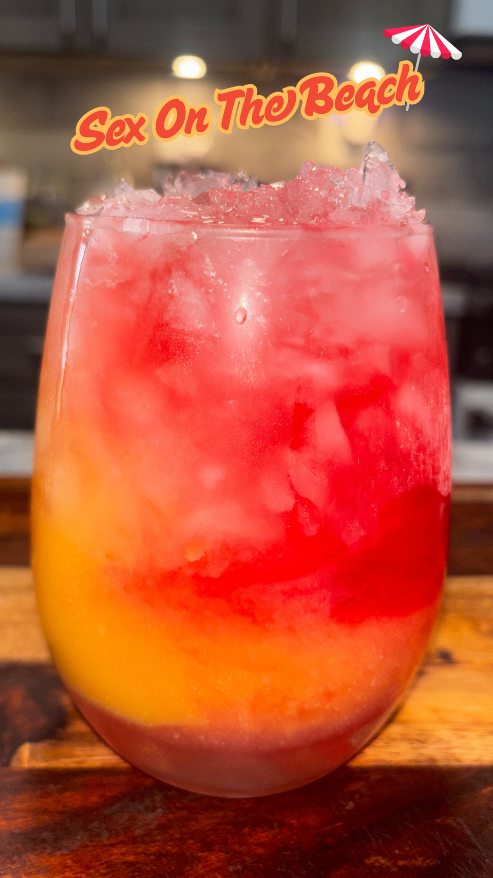 Sex on the Beach cocktail in a tall glass with orange juice, cranberry juice, vodka, peach schnapps, and fruit garnish