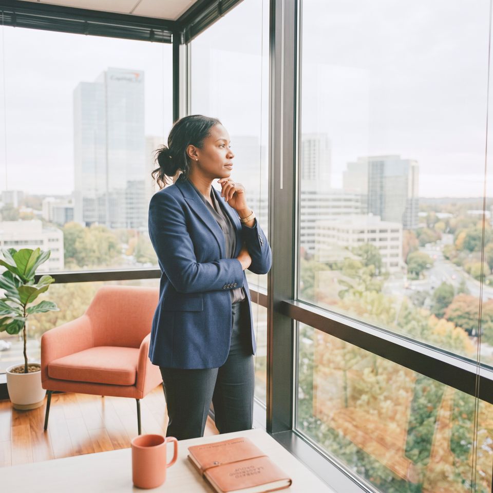 Business founder looking out window 202608102200