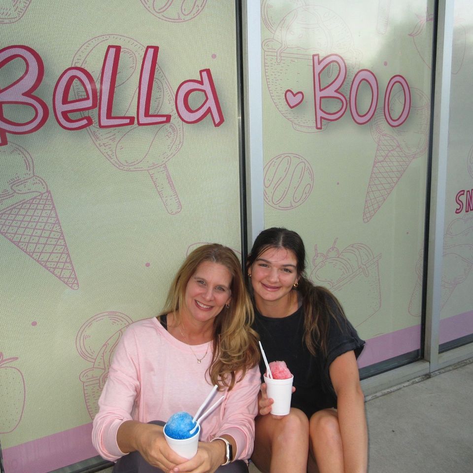 Jessica and Callie enjoying snowballs in front of the shop.
