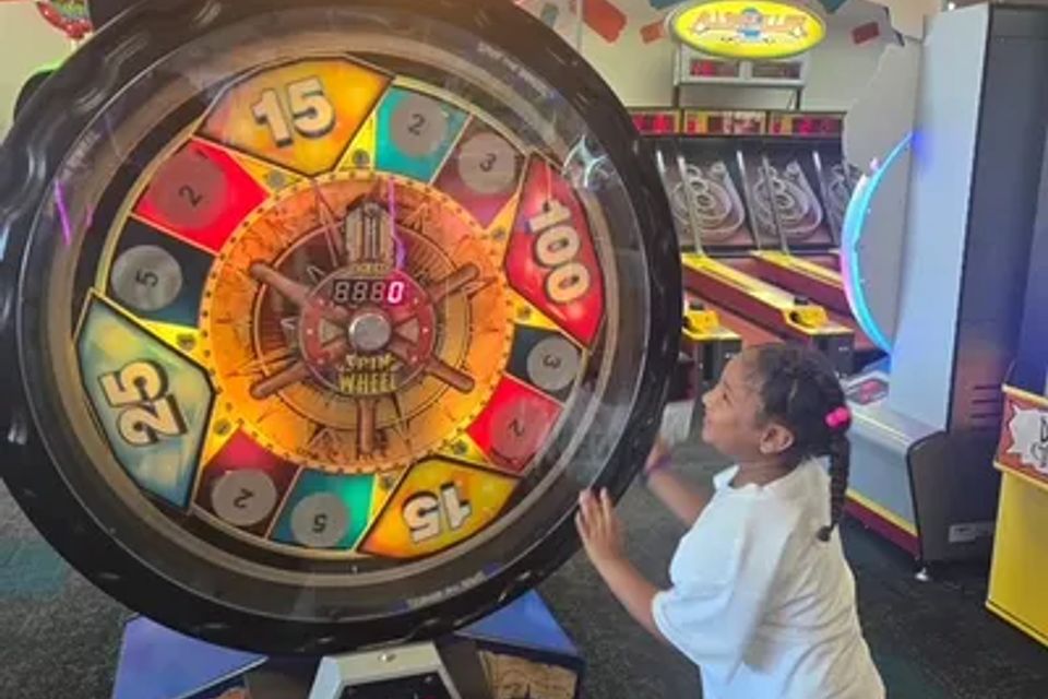 At Chuck E. Cheese, a child is playing the wheel game.