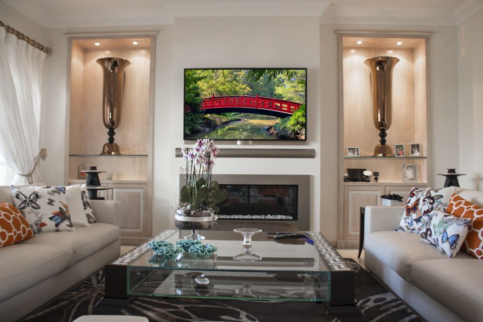 Homeowner enjoying a movie in their living room with a professionally installed audio and video system.