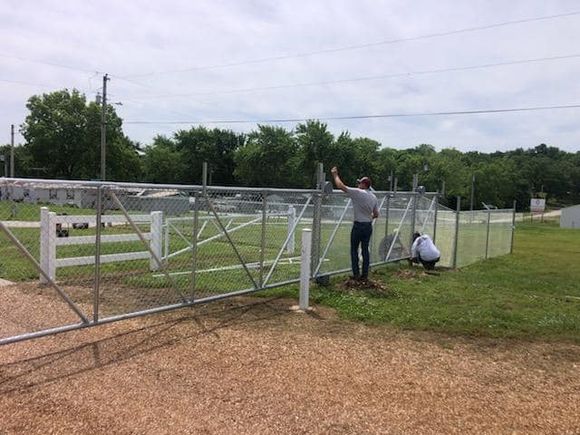 Dore team installing commercial chain link fence