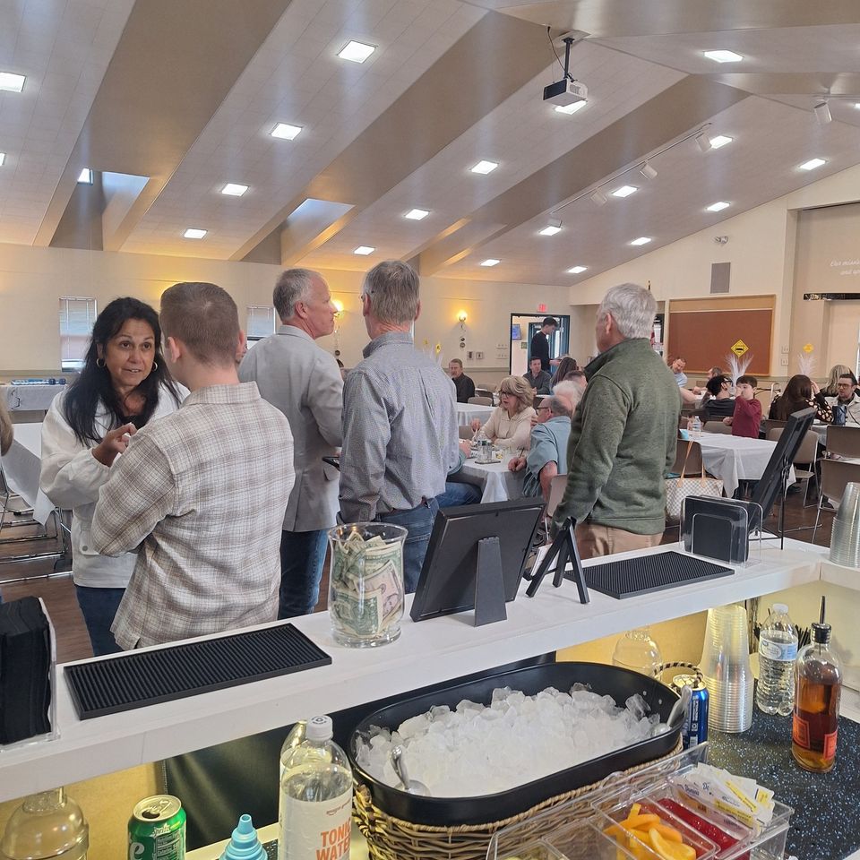 Guests socializing at the retirement party