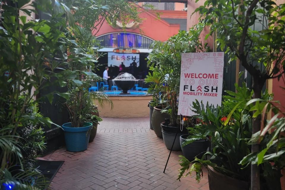 Flash corporate event signage entering the courtyard at the Beach on Bourbon.