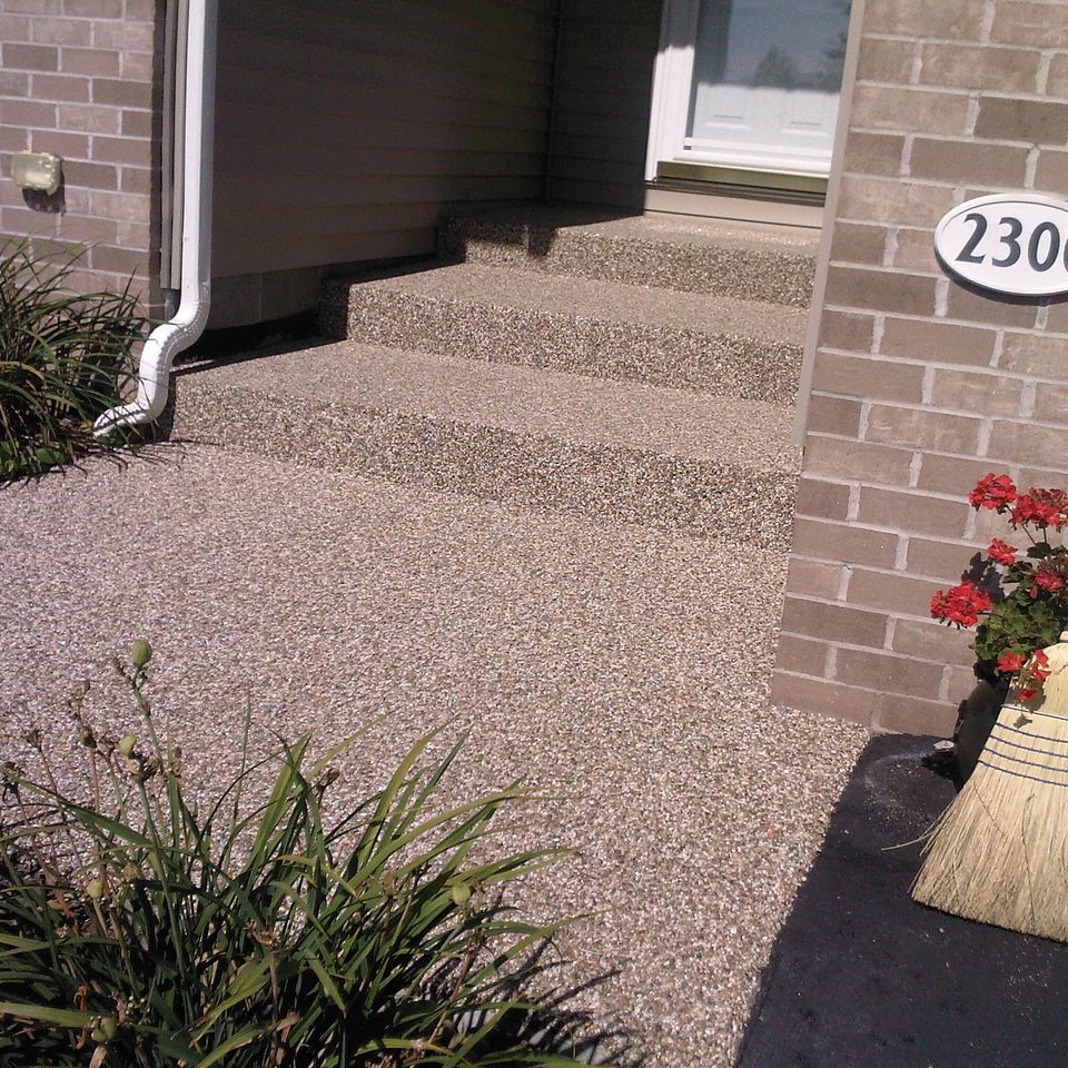 Front entrance with stone epoxy flooring covering the steps and walkway leading to the front door.