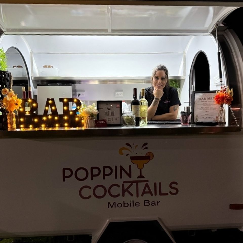 Poppin Cocktails trailer bar with the owner ready to serve drinks