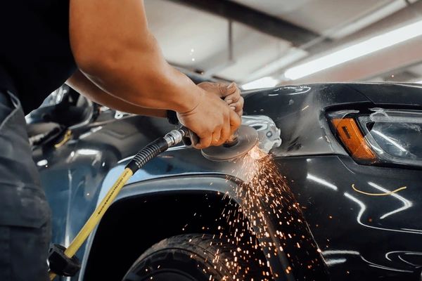 Auto body shop worker grinding 600nw 2400249629