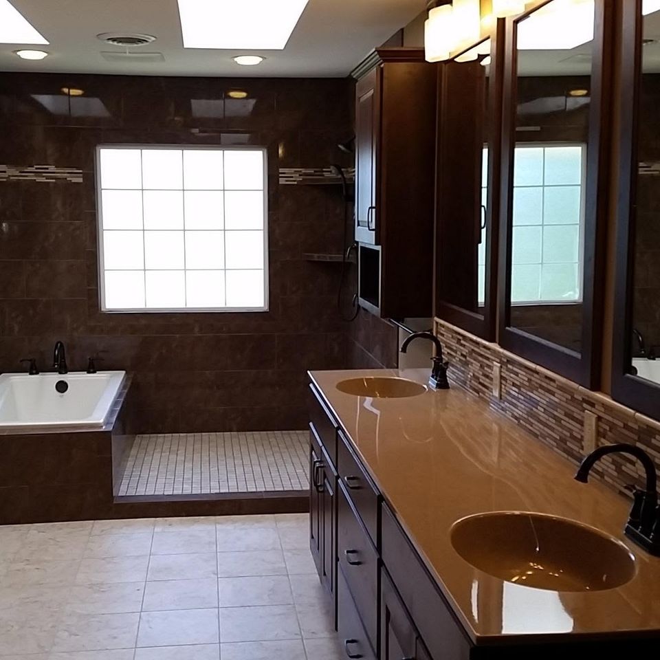 Dark wood primary bathroom tub and vanity