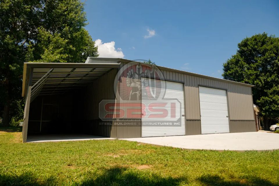 Gray steel garage with roll up doors and side lean to with SBSI watermark representing steel garages in Alabama