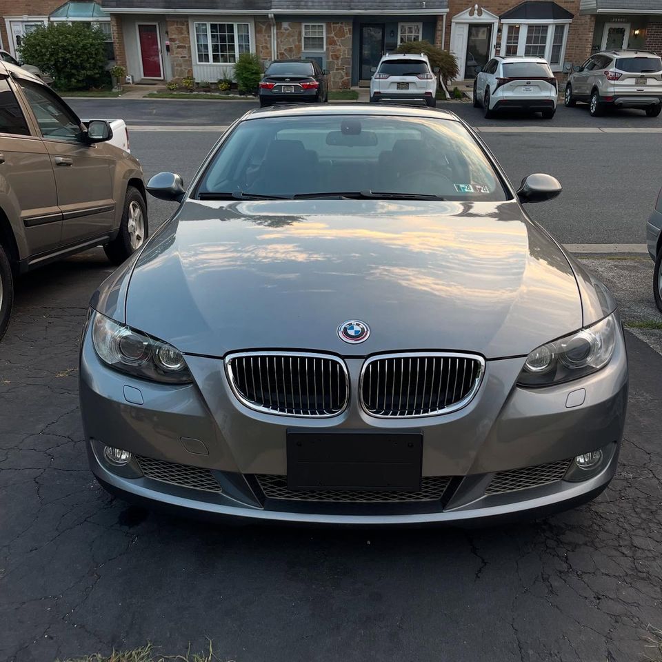 Gray BMW 3 Series coupe with a mirror-like hood shine after exterior cleaning at a Wilmington townhome